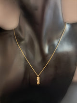 Gold necklace with central element and diamond